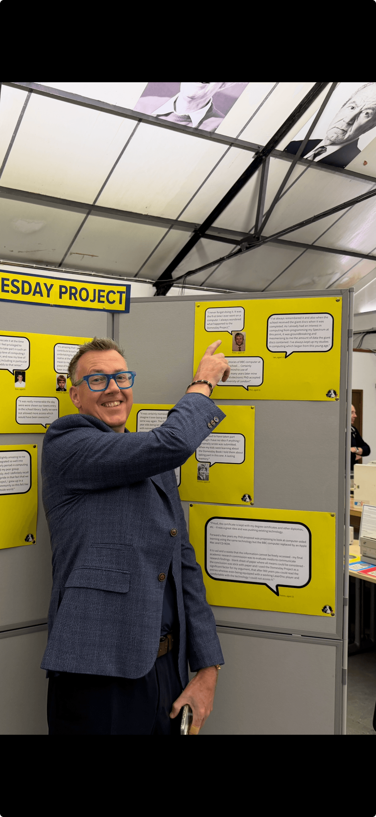 Peter Hanlon pointing at his written comment on the Domesday Project at 40 exhibition wall
